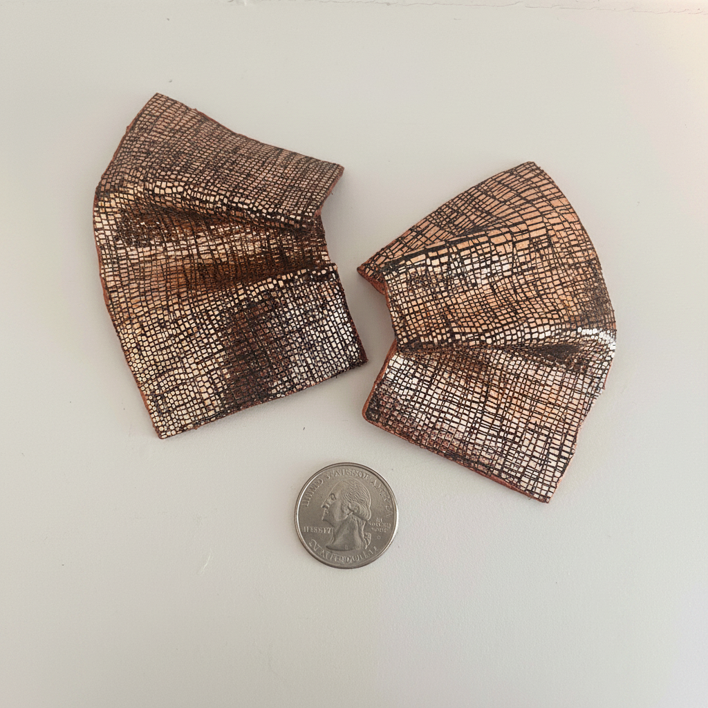 Copper fan earrings with coin on white background