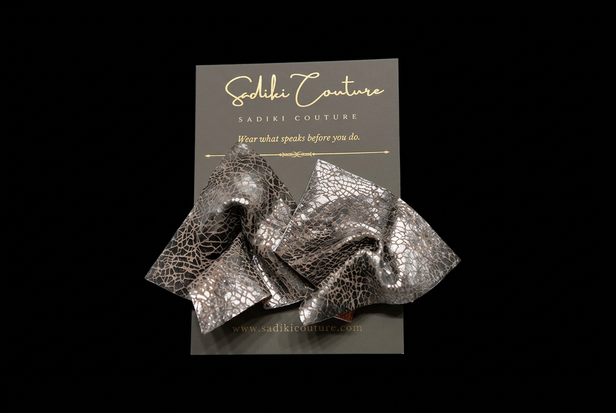 Earrings on their branded card with a black background