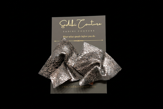 Earrings on their branded card with a black background