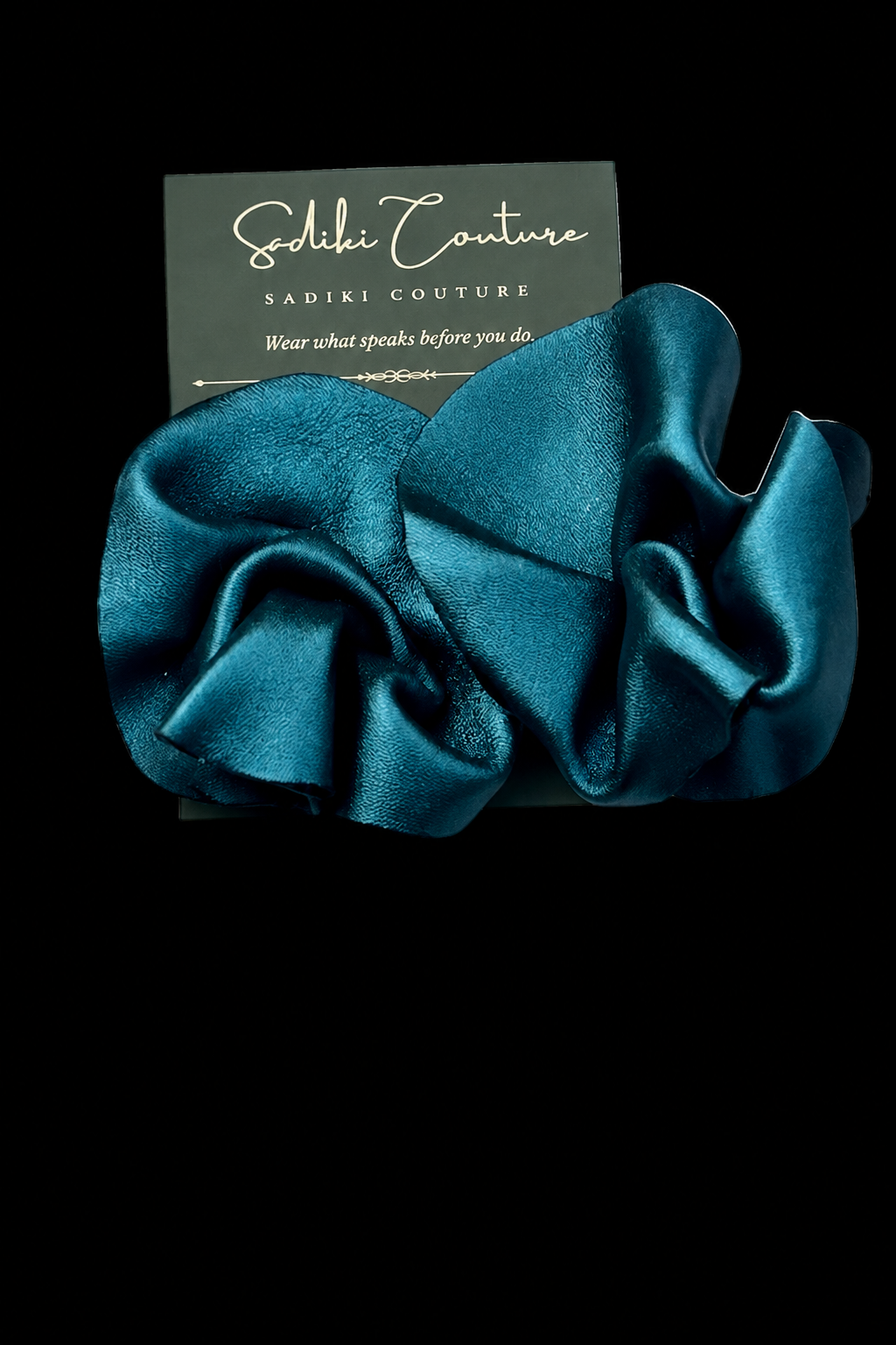 Teal earrings with black background